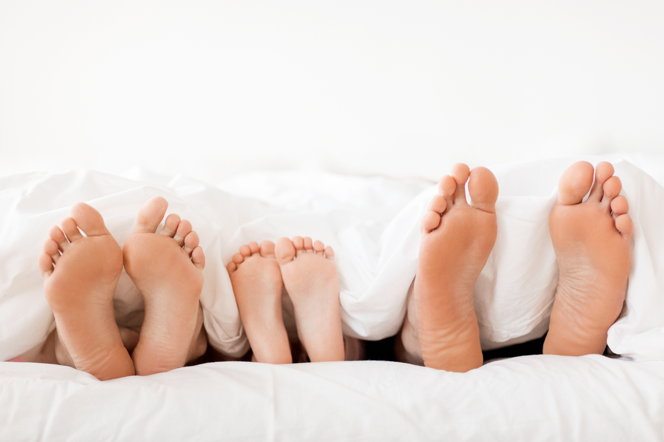 Feet of Family on Bed